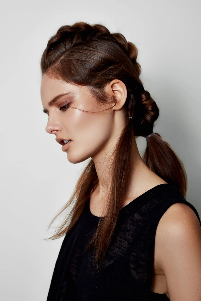 Creative agency hair trend for fashion professionals: elegant low bun with subtle pastel highlights Fashion professional with a creative agency work hairstyle featuring a sleek low bun and hint of color