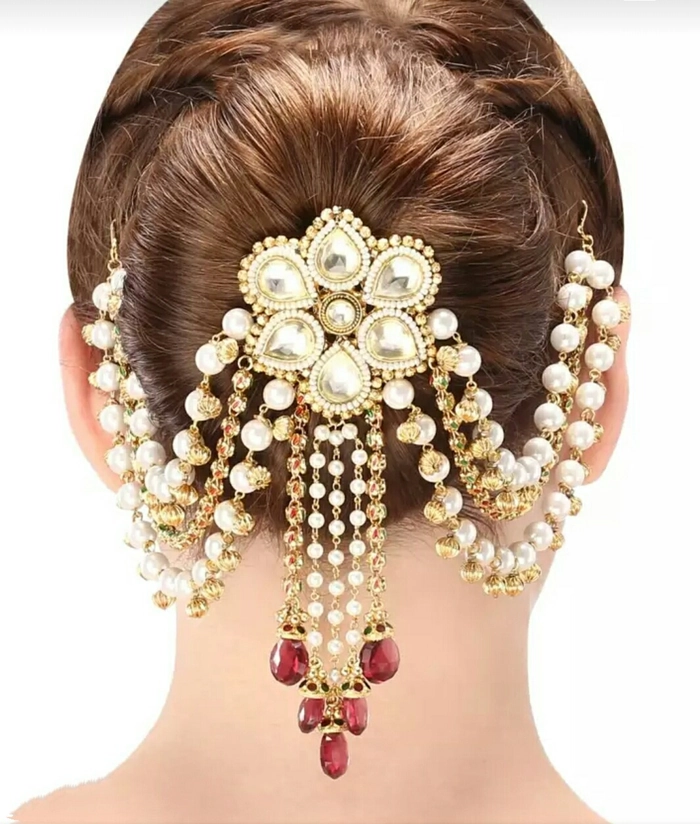 Professional woman with subtle gold hair pins in a low bun for conservative office style