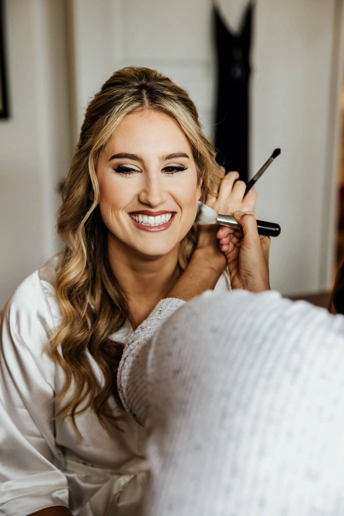 Broadcast journalist quickly fixing her hair with a comb before going on air