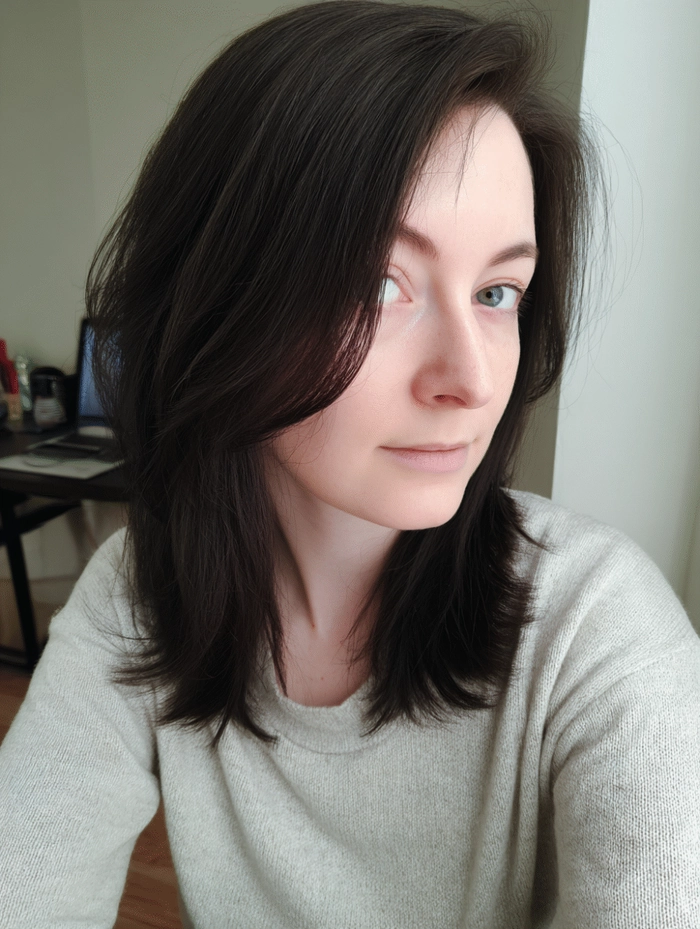 Woman clipping medium length hair into a professional updo for work