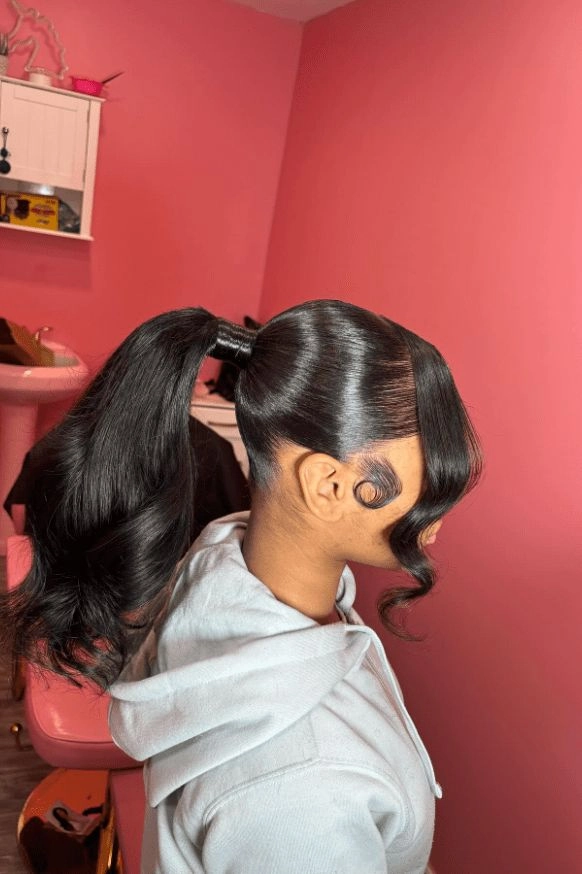 Woman quickly styling her hair with a ponytail wrap before an early morning shift