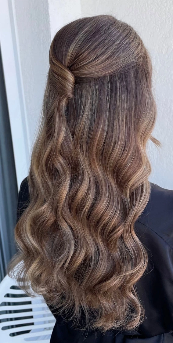 Minimalist half-up half-down work hairstyle with smooth twists and subtle volume