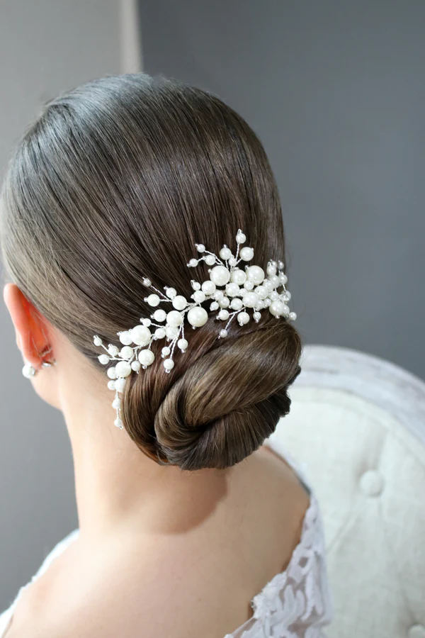 Pearl hair clip arrangement on a sleek corporate updo