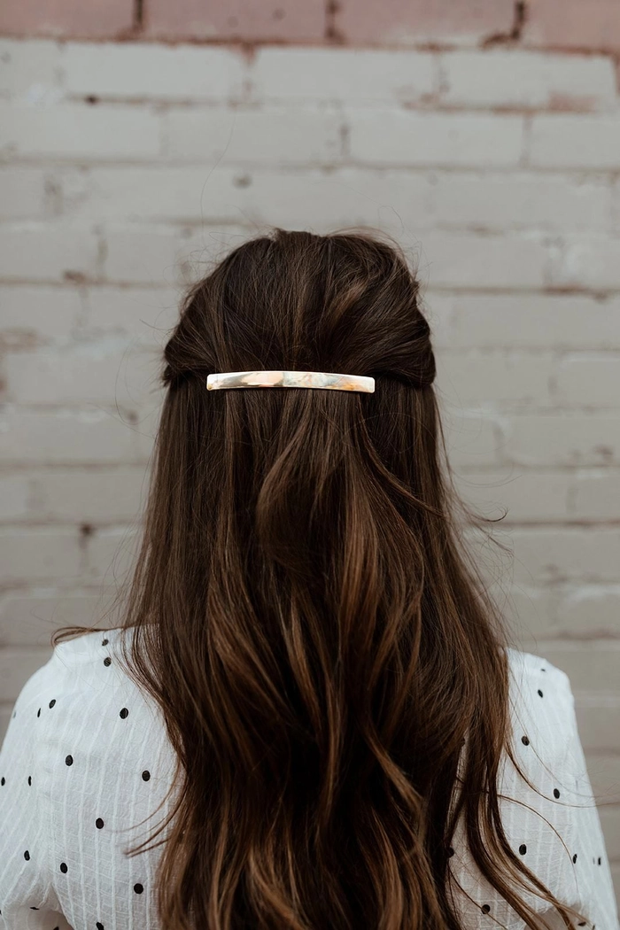 Step-by-step barrette stacking technique on medium length hair for a polished office look