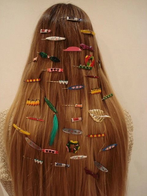 Woman with medium length hair featuring stacked decorative barrettes for a polished office look