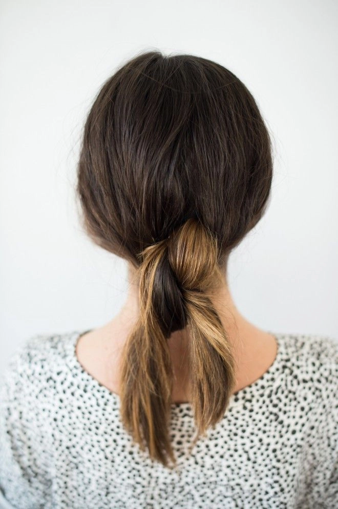 A sleek knotted low ponytail with minimalist charm for the modern office