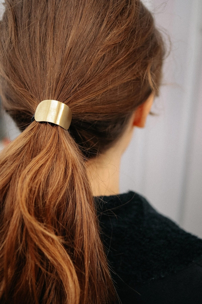 Metal hair cuff used in professional ponytail hairstyle Sleek corporate ponytail with a metal hair cuff accessory