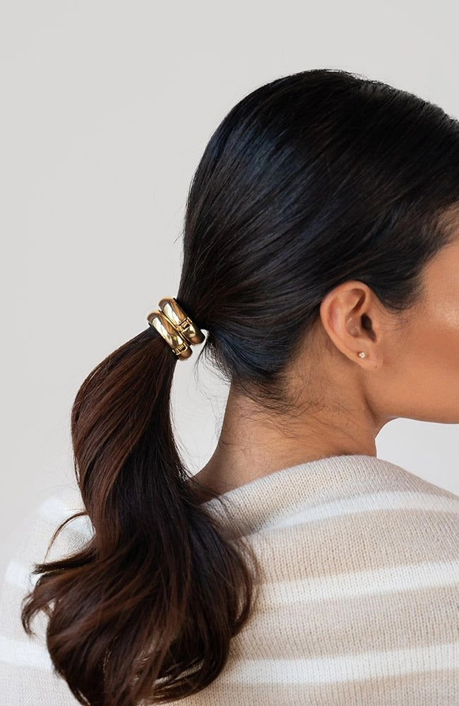 Metal hair cuff accenting a polished ponytail for the office Professional woman with sleek corporate ponytail secured by a metal hair cuff