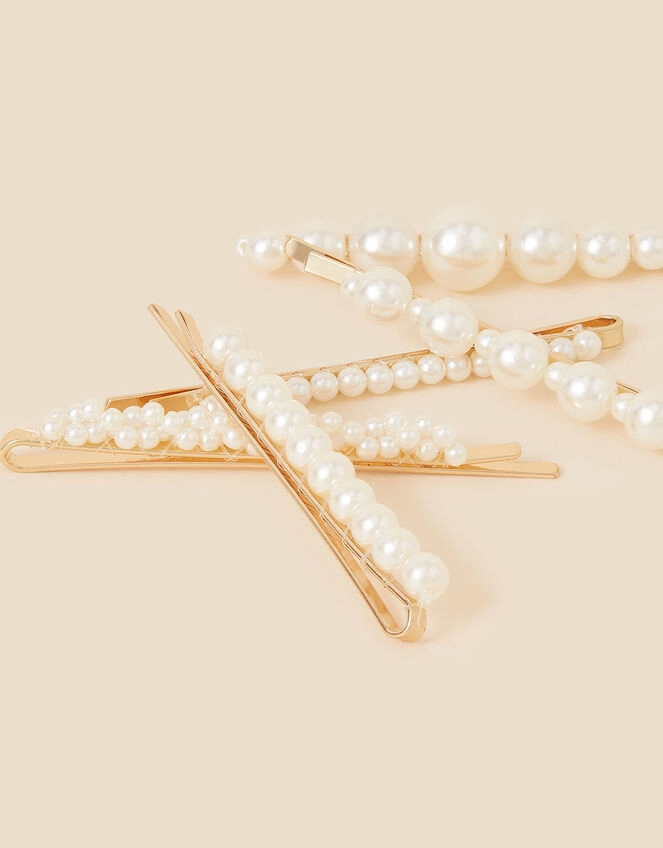 Pearl hair clip arrangement in a sleek corporate updo