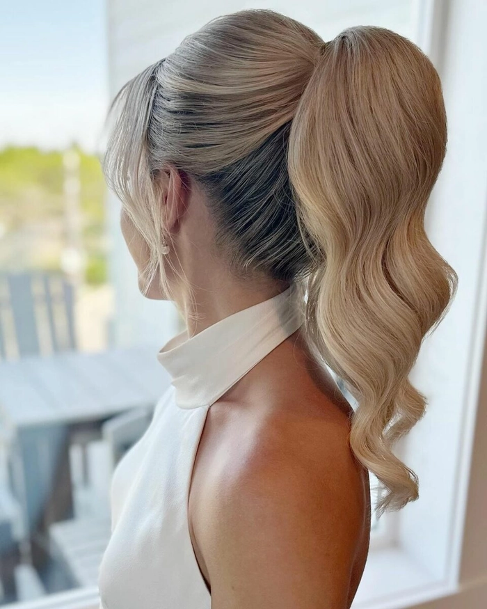 A professional polished ponytail with sleek sides and volume at the crown for client meetings