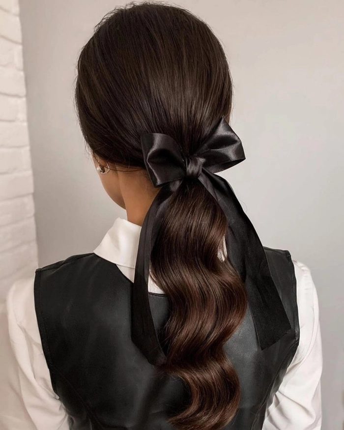 Long hair styled in a polished office updo with soft curls Elegant professional office hairstyle for long hair with smooth waves pinned back