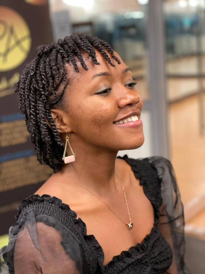 Professional protective hairstyle for coily natural hair with defined curls Protective work styles for coily natural hair in a polished bun