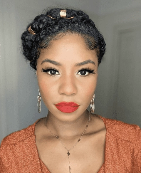 Protective updo for coily natural hair with elegant styling suitable for office environments Coily natural hair styled in a protective bun with satin scarf for a professional work look