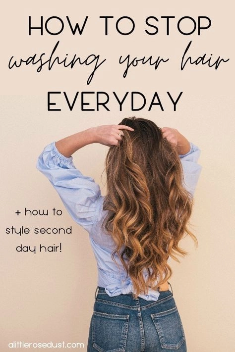 Woman spritzing dry shampoo on second day hair for a fresh office look