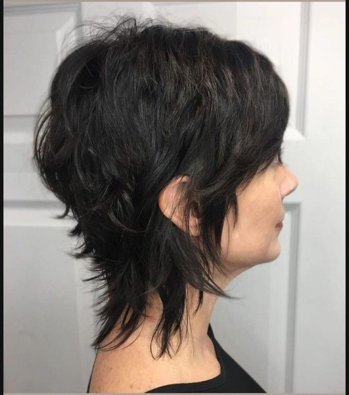 Modern shag haircut adaptation for a creative professional over forty, styled with textured layers and soft waves for a polished work look
