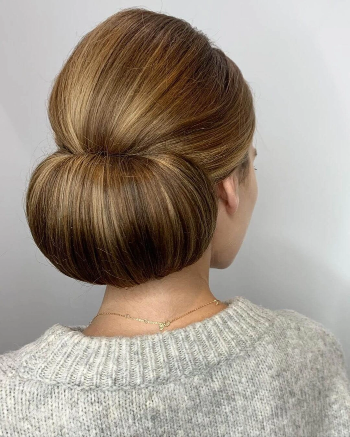 Professional woman with sleek low bun hairstyle for a job interview