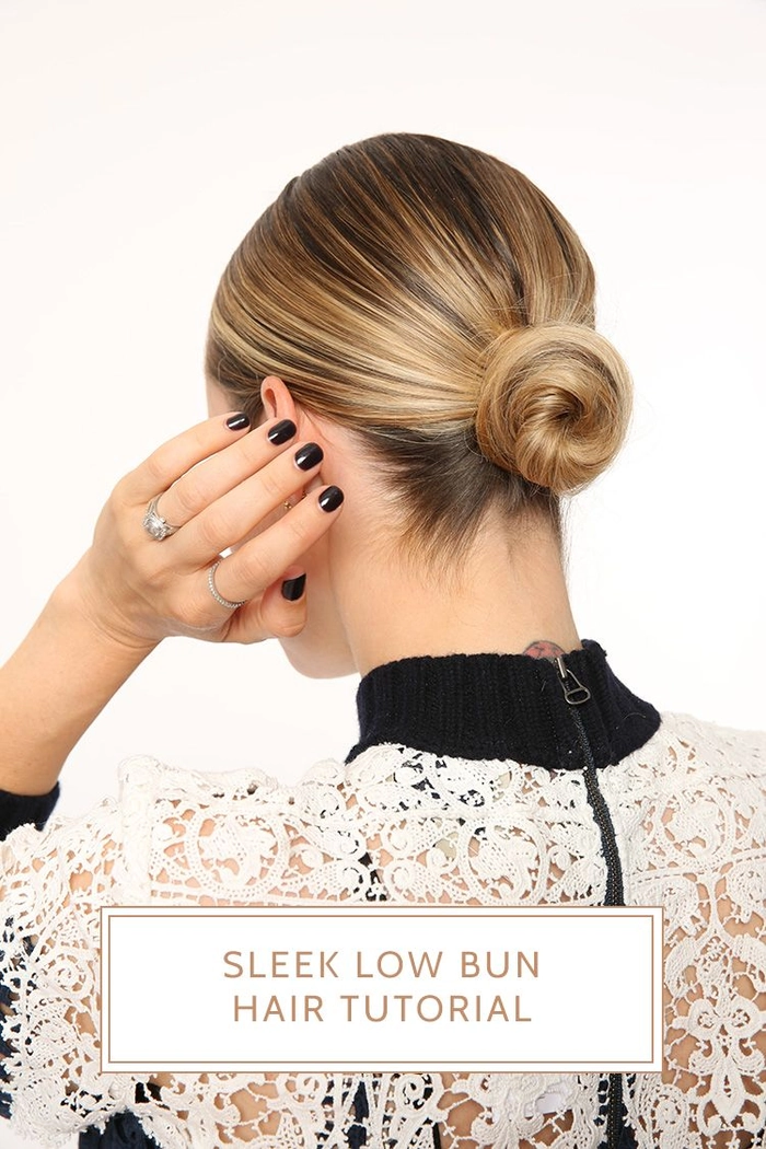 A sleek low bun hairstyle for job interviews, with smooth hair and a polished finish