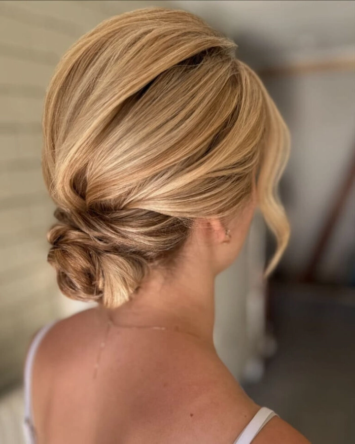 Sleek Middle Part Low Bun for a Confident Executive Presentation Look A sleek, polished low bun with a sharp middle part, ideal for executive presentations and professional settings