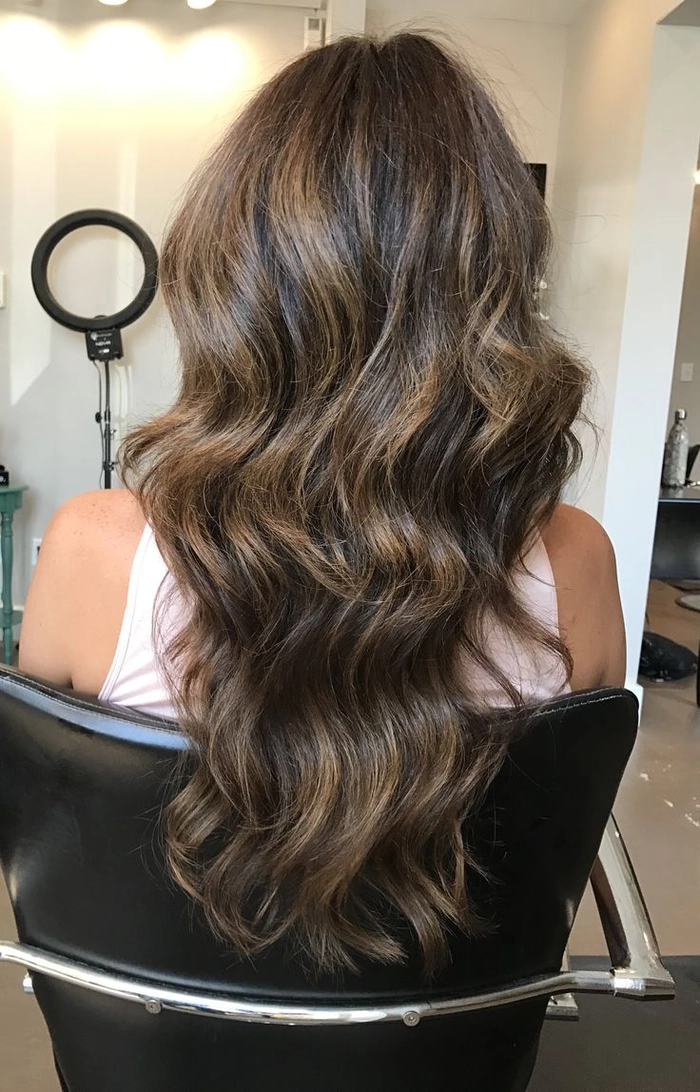 Curly hair blow-dried straight and smooth for a polished office look