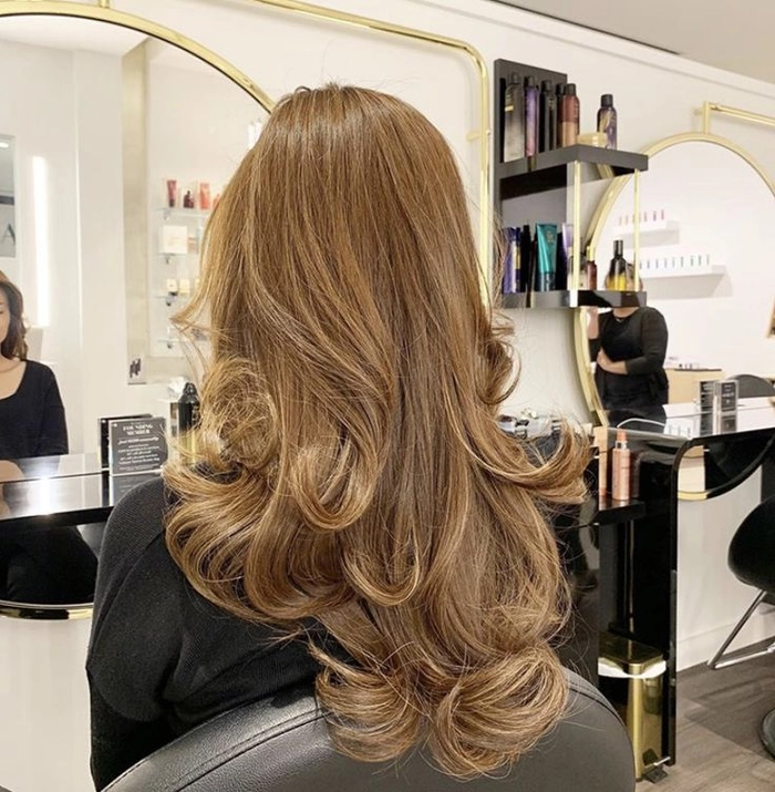 Sleek office blowout hairstyle for curly hair styled for a professional workplace