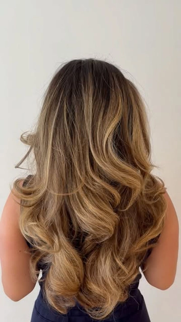 Sleek blowout styling for curly hair at the office