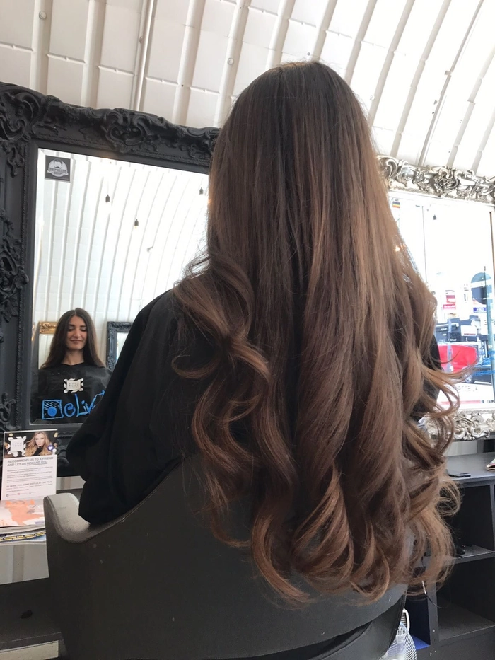 Professional blowout styling for curly hair in office setting