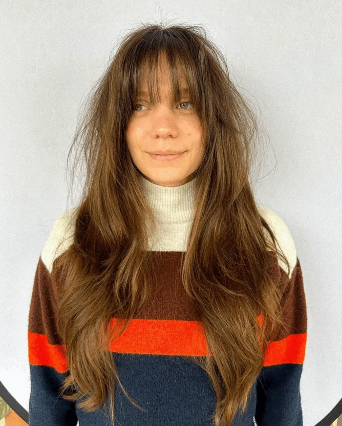 Professional side-swept bangs softening a square face for a corporate hairstyle