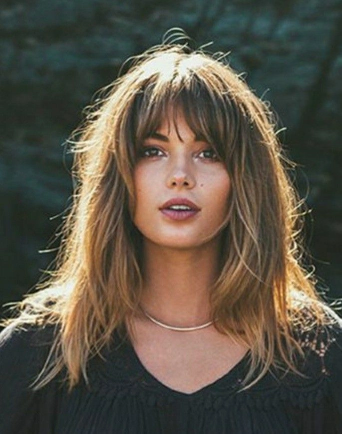 A corporate professional with a square face and soft, side-swept bangs ideal for office settings