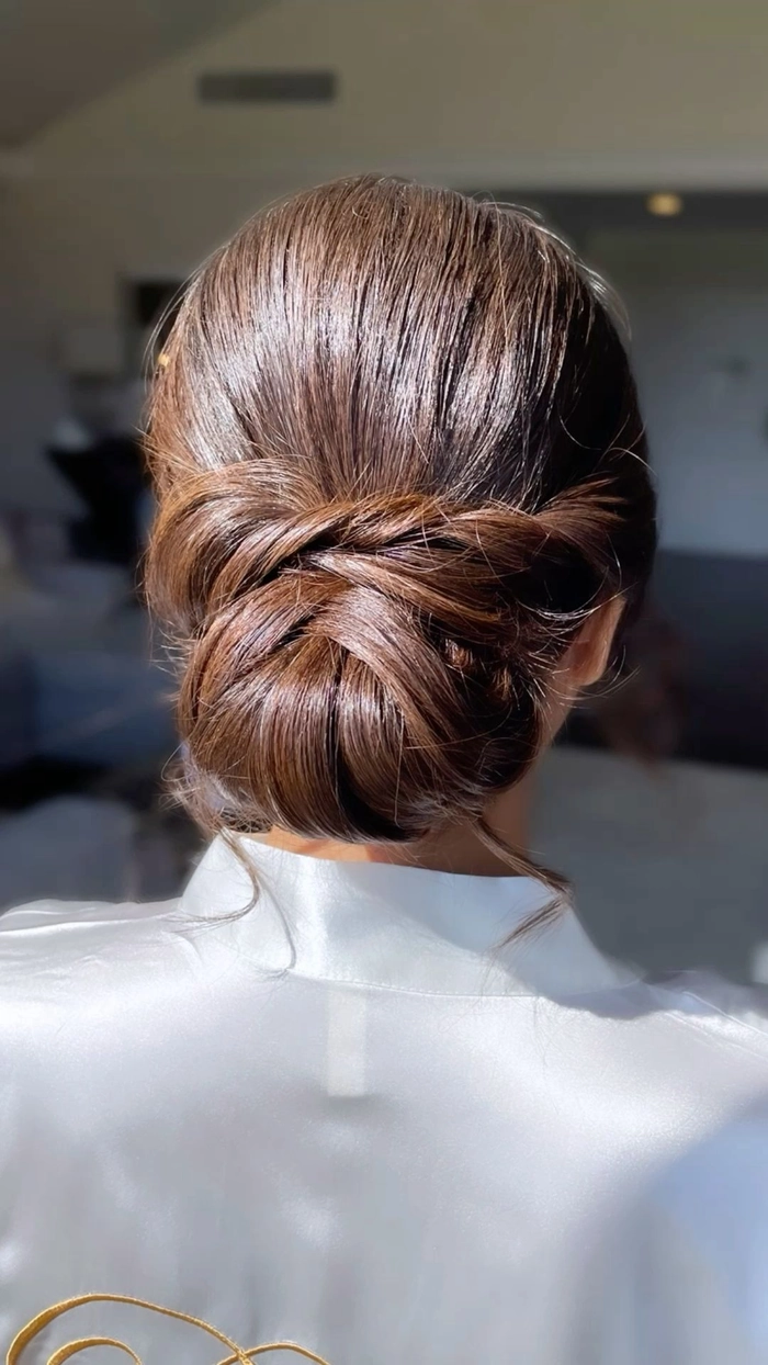 Professional low chignon hairstyle for a female executive in a business setting