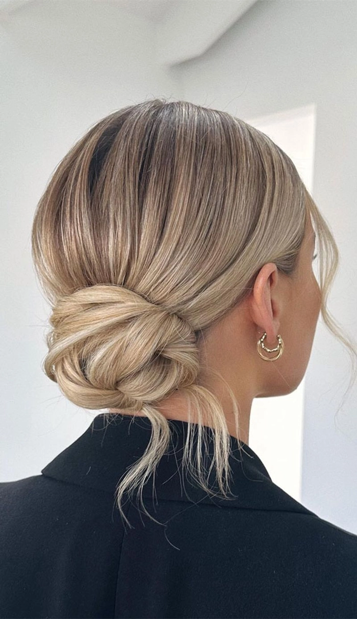 A polished low chignon with sleek sides for a professional executive look