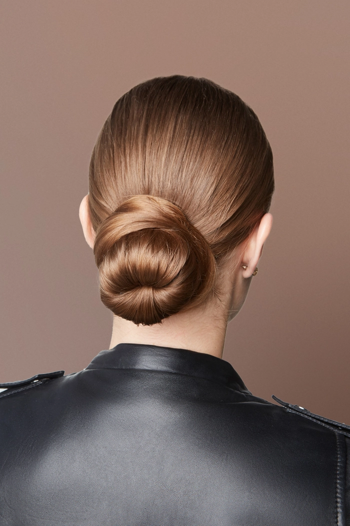 Sophisticated chignon hairstyle for female executives in a professional office setting