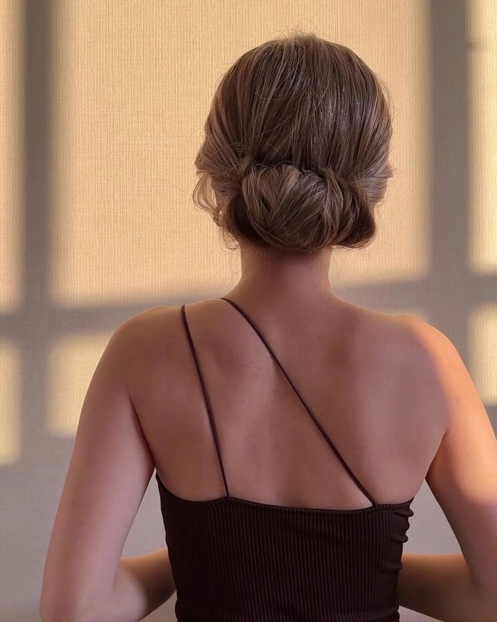 Professional woman with sleek low chignon hairstyle for office