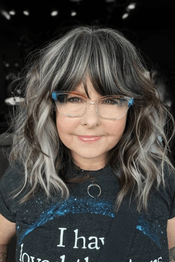 An older executive with sophisticated gray hair blending styled for a professional work environment