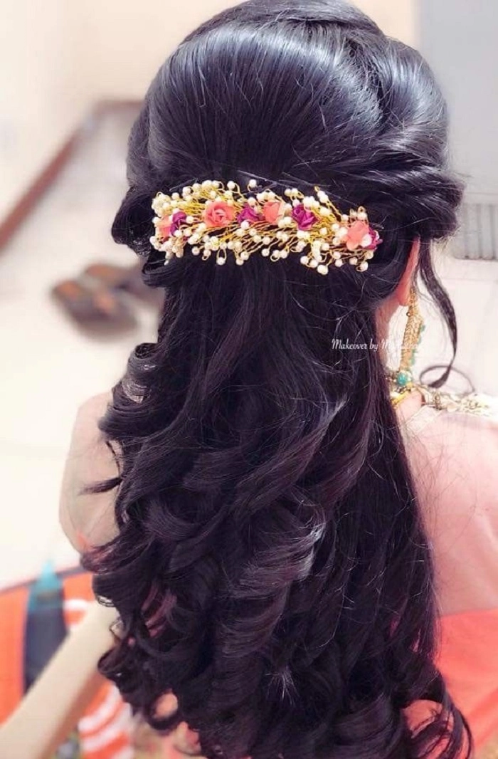 Woman with a spring floral hair clip in a casual office hairstyle, blending blooms into a low ponytail