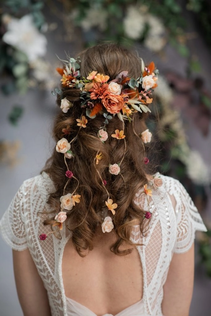 Woman with a low ponytail featuring a small spring floral clip at a casual office desk