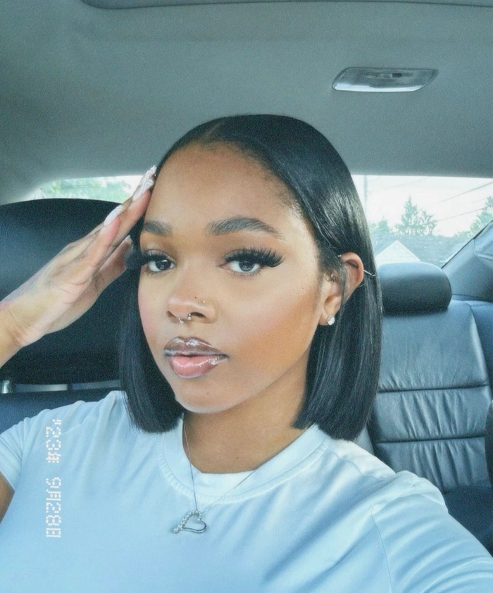 Tips for keeping your straightened bob fresh during a nine-to-five workday Woman with a sleek straightened bob hairstyle checking her reflection before a work shift