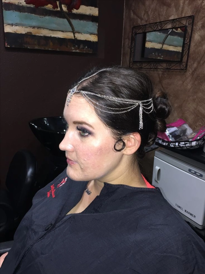 Subtle hair pins and small metallic clips blending into a neat low bun for a professional office look