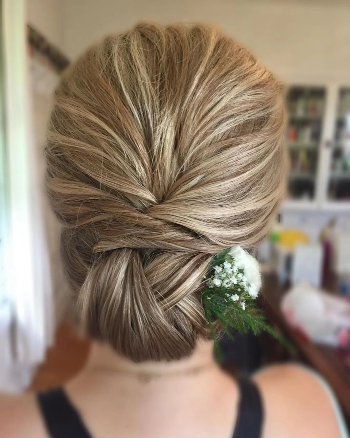A textured low chignon hairstyle styled for a professional creative industry meeting