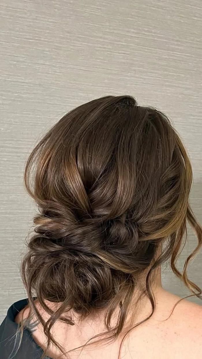 A creative professional with a textured low chignon, perfect for industry meetings