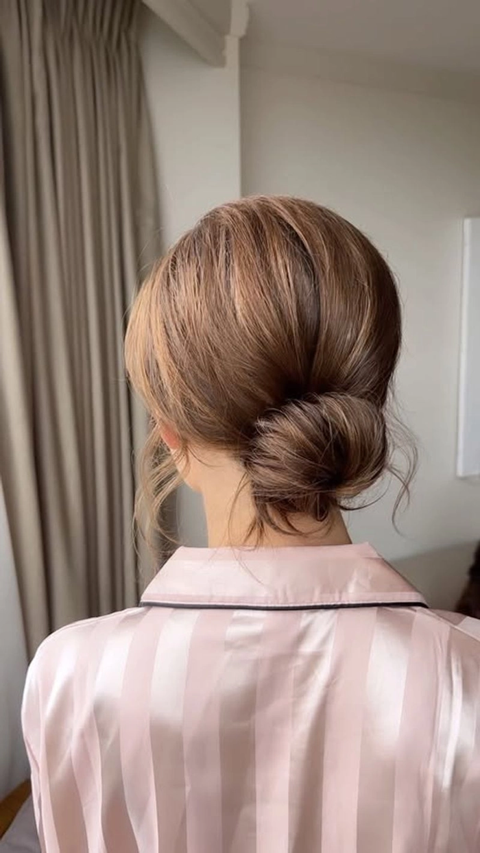 Refined textured low chignon hairstyle for creative industry meetings