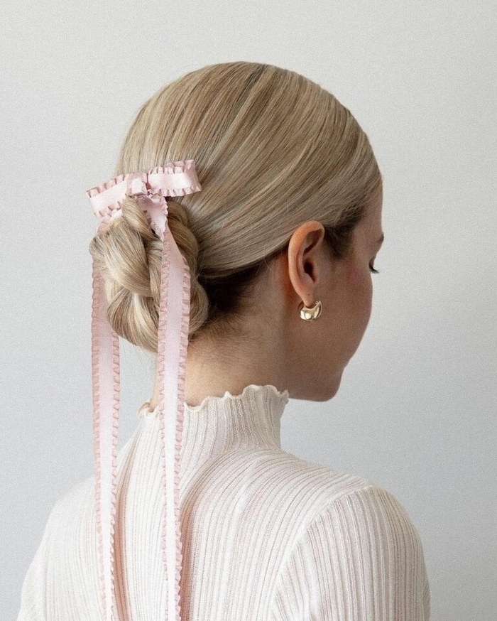 a creative professional with a textured low chignon hairstyle suitable for industry meetings