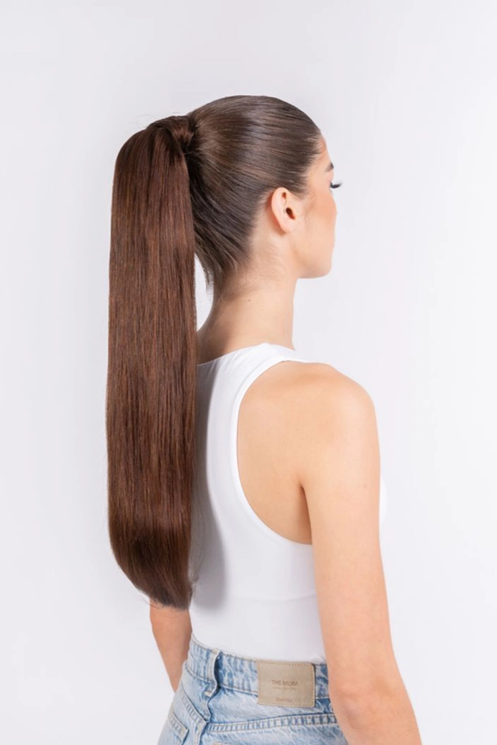 Woman with a sleek ponytail wrap hairstyle for an early work shift