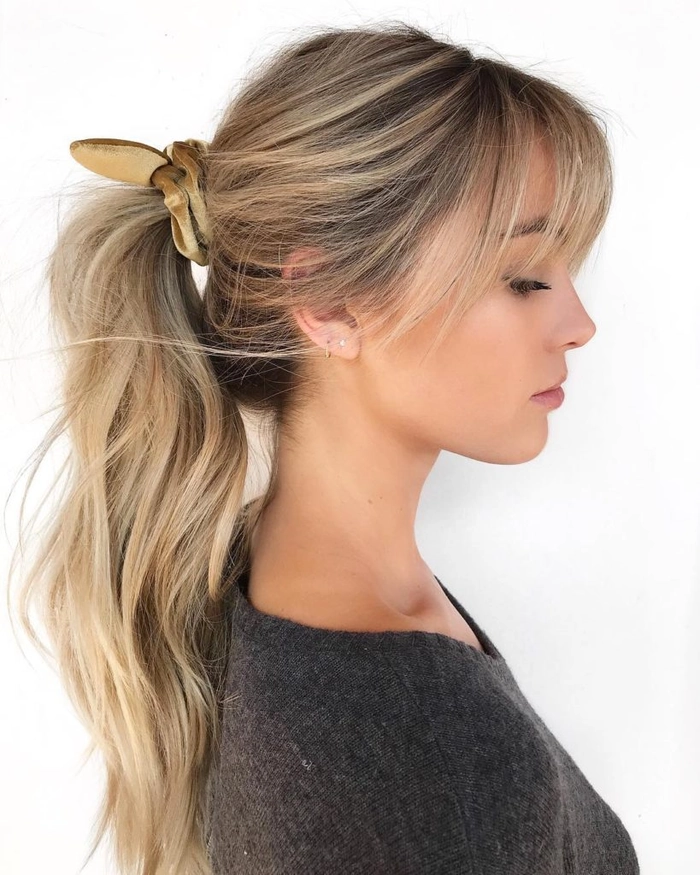 Velvet scrunchie styling for a polished work ponytail hairstyle Professional woman wearing a velvet scrunchie in a sleek business casual ponytail for the office