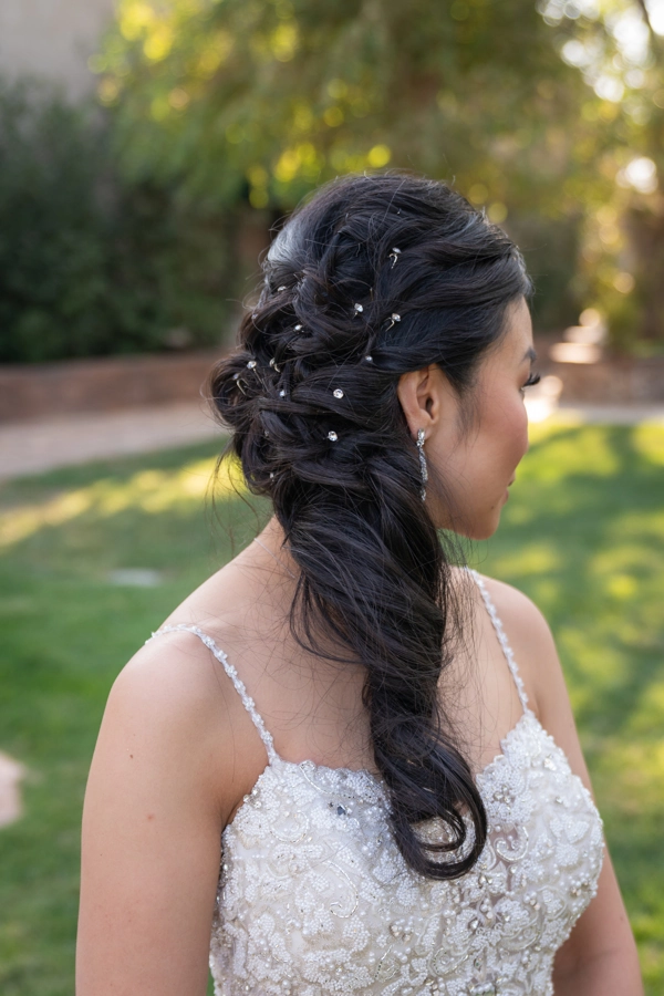 Wind-resistant braided updo hairstyle for outdoor corporate events Professional woman with a wind-resistant braided updo at an outdoor corporate event